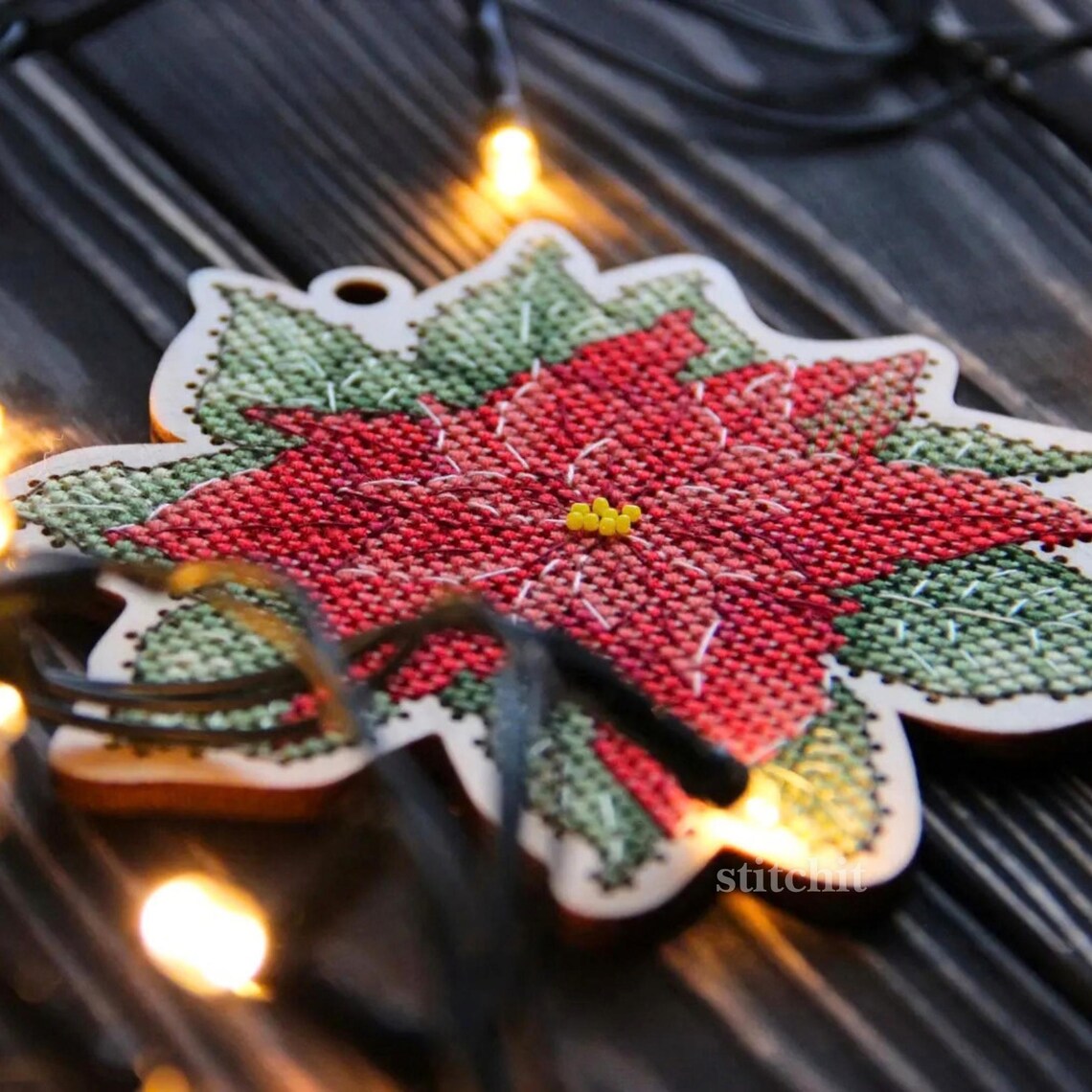 Modern Embroidery Kit On Wood | Christmas Poinsettia | Product Closeup With Christmas Lights
