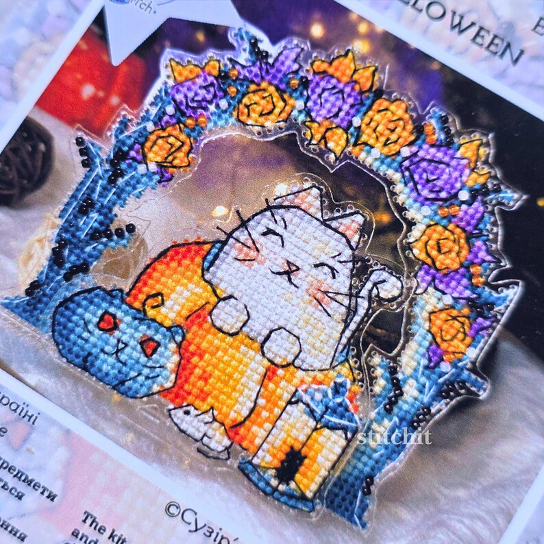 Cat Pumpkin Cross Stitch Kit — close-up detail of beaded cat with pumpkin under floral arch