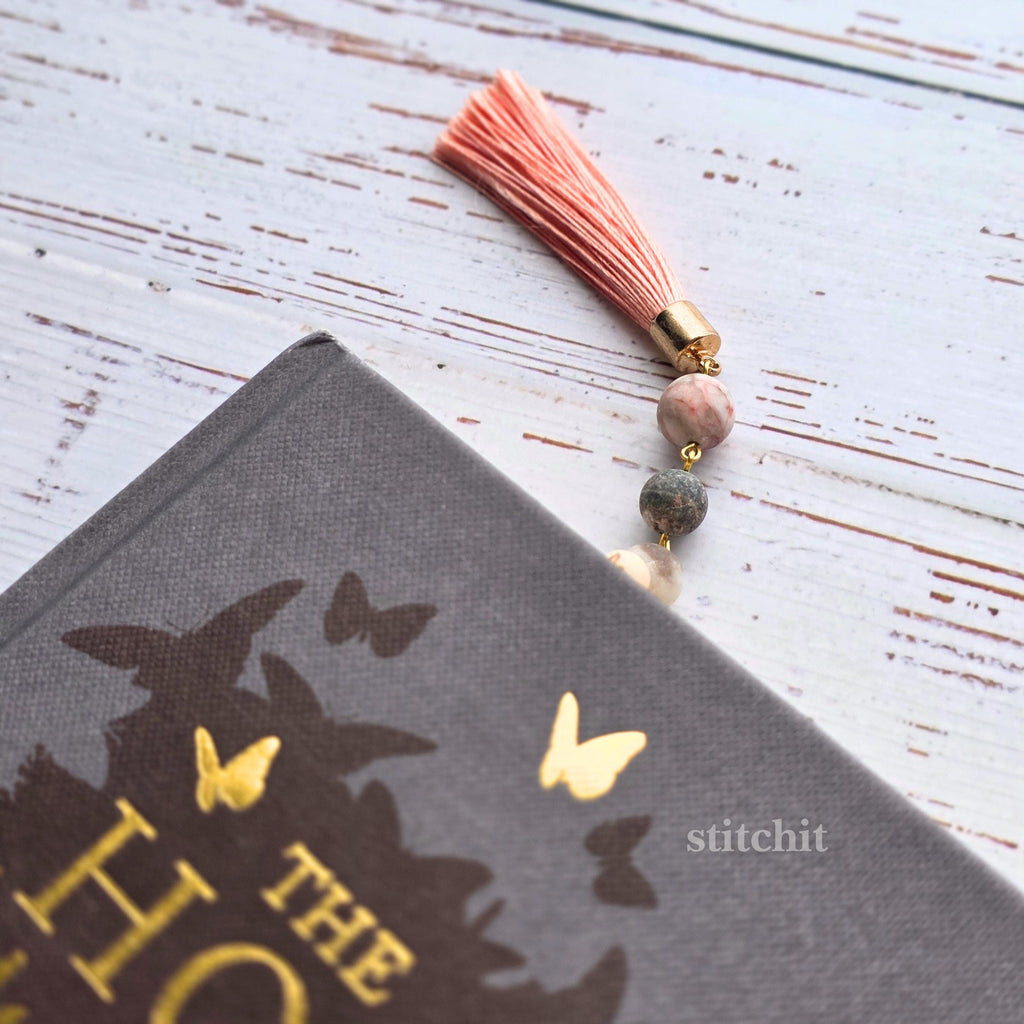 Cross Stitch Bookmark Kit on Plastic Canvas showing a book with a decorative tassel and beads.