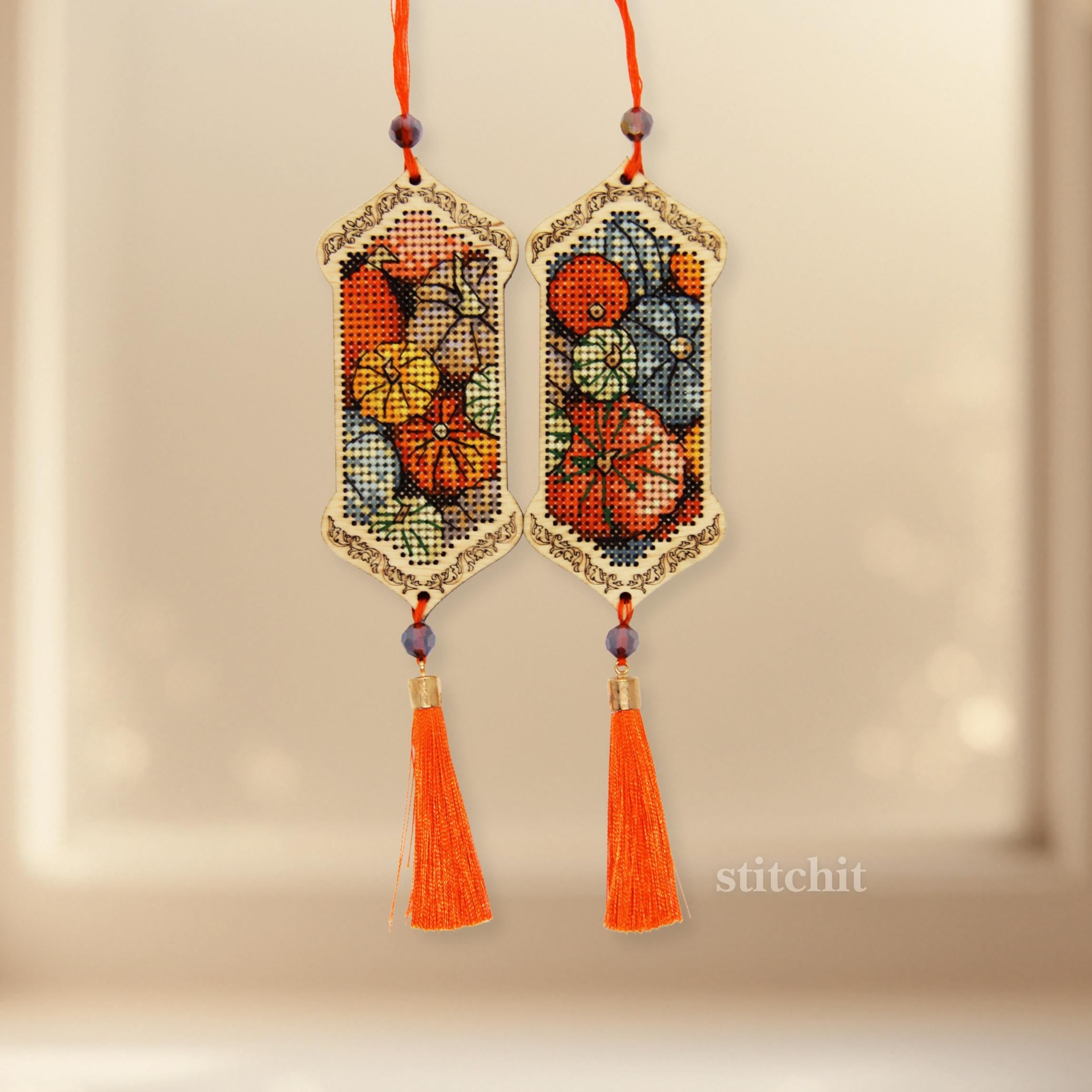 Pumpkin Cross Stitch Kit on Wood featuring fall décor wooden ornaments with tassels and beads.