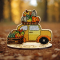 Autumn Car Cross Stitch Kit on Wood featuring a yellow truck filled with pumpkins and vegetables on a wooden base.