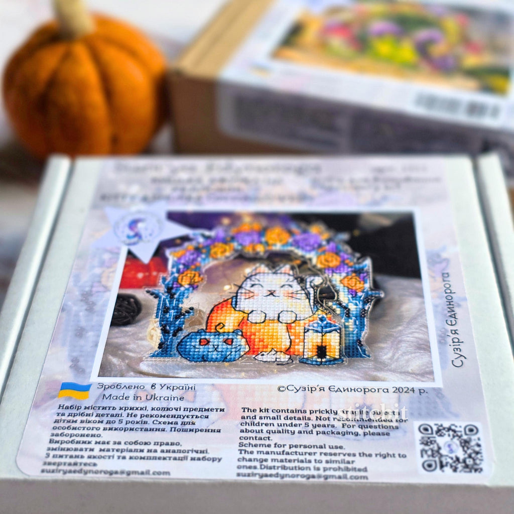 Cat Pumpkin Cross Stitch Kit — back of box showing finished cat on pumpkin under arch with lanterns